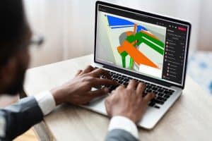 Gebruiker werkt aan 3D-ontwerp op laptop.
